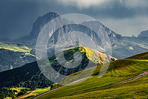 Gloomy summer view of Sassolungo Langkofel and Sella group, National Park Dolomites, South Tyrol, Italy, Europe. Picturesque mor