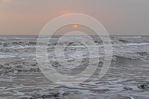 Gloomy sunrise at stormy sea landscape