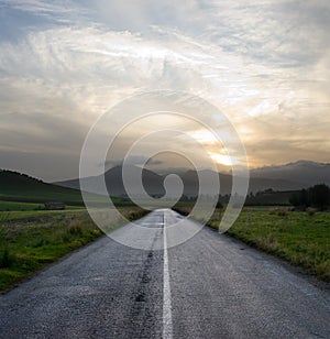 Gloomy sunset on the empty road photo