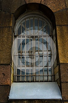 Gloomy window with grating.