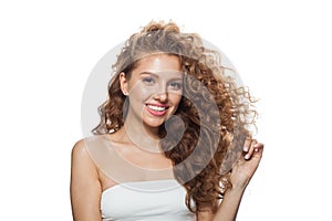 Glorious fashion model with frizzy hair, natural makeup and healthy clean skin posing on white background. Skincare, haircare