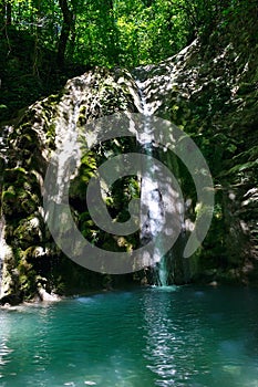 Glorious refreshing waterfall among rocks in a mountain forest