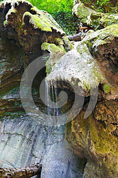 Glorious rocks with old moss and flowing streams of water