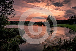 A glorious sky as the sun sets over the lake at Hardwick Park in Sedgefield, County Durham