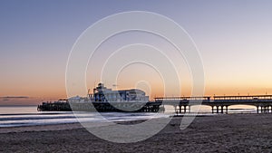 Glorious sunset over the beautiful pier and the sandy beach of Bournemouth, England