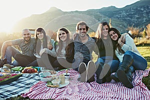 Glorious times with good friends. Portrait of a group of friends having a picnic together outdoors.