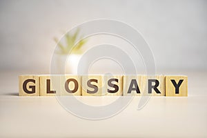 Glossary word made of square letter word on sunny background