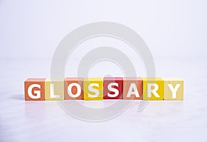 Glossary - word from wooden blocks with letters, alphabetical list with words meanings dictionary glossary concept, top view on