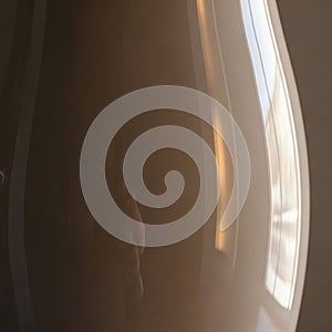 Glossy curved surface with a blurred reflection suggesting a