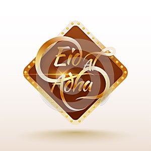 Glossy golden typographic text Eid-Al-Adha in brown square frame