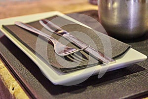 Glossy Metal Fork And Knive On a Black Napkin photo