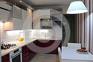 Glossy modern kitchen with white top and cherry bottom