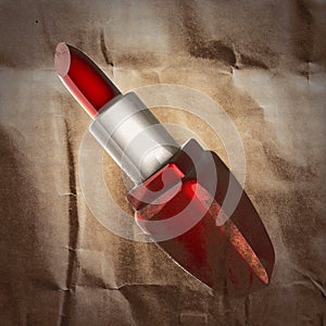 Glossy red lipstick painted on paper