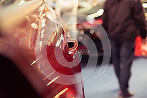 A glossy red painted car door with door edge,Color detail of a r