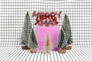 glossy red plastic Christmas ornament featuring a text saying merry xmas and a miniature forest scene
