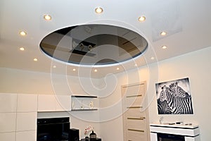 A glossy stretch ceiling in a living room interior
