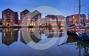 Gloucester docks and sail boats reflected in quay on Sharpness canal