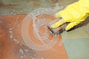 Gloved hand cleaning of dirty filthy floor