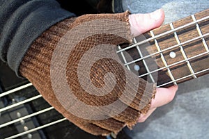 Gloved Hand on Frets