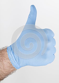 Gloved hand gives thumbs-up gesture