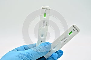 Gloved hand holding an antigen test photo