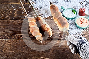 Gloved hand holding a barbecued twist bread