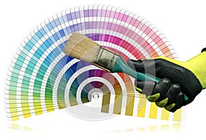 Gloved Hand Holding a Paintbrush with Pantone Color Swatches on Background