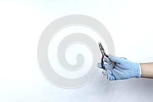 Gloved hand holding pliers
