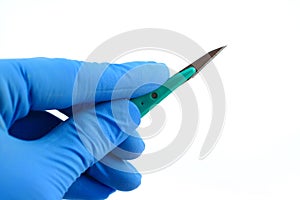 Gloved hand holding scalpel photo