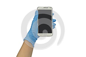 Gloved hand holding smart phone on white background.