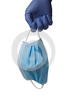 Gloved hand holding a surgical mask photo