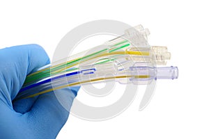 Gloved hand holding surgical tubing photo