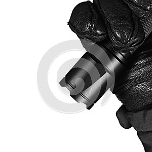 Gloved Hand Holding Tactical Flashlight, Bright Light Emiting Brightly Lit, Serrated Strike Bezel, Black Grain Leather Glove