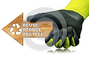Gloved Hand Holding a Wooden Arrow with Text - Reuse Reduce Recycle