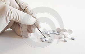Gloved hand and medicinal pills