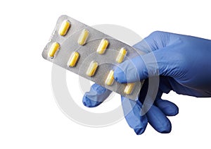 Gloved Hand Offers Blister of Yellow Pills - Isolated Photo photo