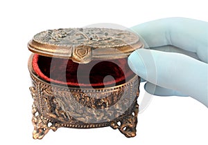 Gloved hand, opening a copper box for jewelry