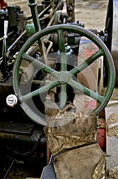 Gloved hand operates an old steering wheel