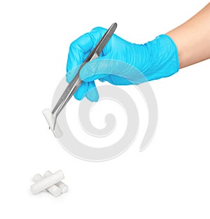 Gloved hand takes tweezers sterile cotton swab