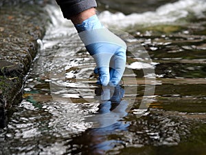 Gloved hand into the water collecting tube. Analysis of water purity, environment, ecology - concept. Water testing