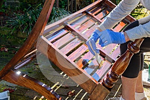 Gloved Hands Applying Varnish to Bench