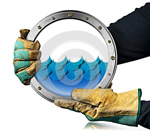 Gloved Hands Holding a Metal Porthole with Blue Waves