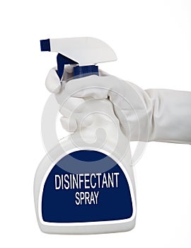 A gloved hands holding a spray bottle of cleaning, disinfecting chemical on a white background