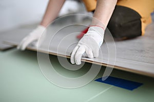 Gloved technician lays down laminate on backing