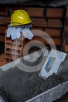 Gloves, helmet and goggles on pile of bricks