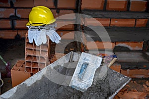 Gloves, helmet and goggles on pile of bricks