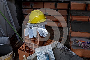 Gloves, helmet and goggles on pile of bricks