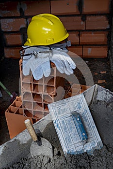 Gloves, helmet and goggles on pile of bricks