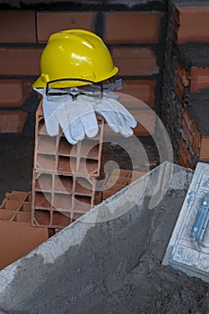 Gloves, helmet and goggles on pile of bricks photo