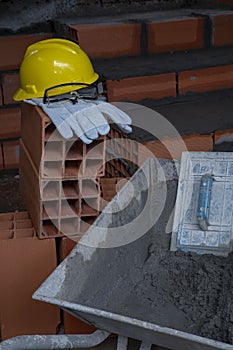 Gloves, helmet and goggles on pile of bricks photo